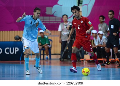 BANGKOK, THAILAND - NOVEMBER 11: Jetsada Chudech Of Thailand (red) In Action During The FIFA Futsal World Cup  Between Thailand And Spain At Nimibutr Stadium On Nov11, 2012 In Bangkok,Thailand.