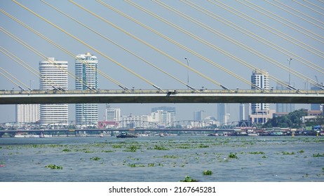 Bangkok, Thailand - November 15, 2020: Close-up view of the middle of Rama VIII Bridge, a cable-stayed bridge with bangkok skyline and Krung Thon Bridge in background