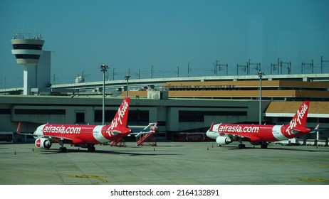 Bangkok, Thailand - November 16, 2020: Two Aircraft Of Thai AirAsia Type Airbus A320 Are Parked At The Apron At Don Mueang Airport Near ATC Tower