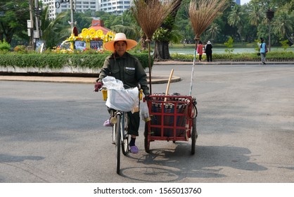 BANGKOK, THAILAND - NOVEMBER 17, 2019: A Woman Rides A Bicycle Holding A Garbage Trolley Wheel Barrow On November 17, 2019 In Bangkok, Thailand