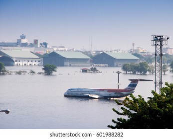 BANGKOK, THAILAND - November 18, 2011:  Airplanes sitting on a flooded runway at Don Muang International Airport in Bangkok, Thailand. The airport is closed due to severe flooding in the Thai capital.