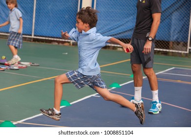 BANGKOK, THAILAND - NOVEMBER 22, 2012: In A College In Bangkok, School Children Take An Outdoor Tennis Lesson.