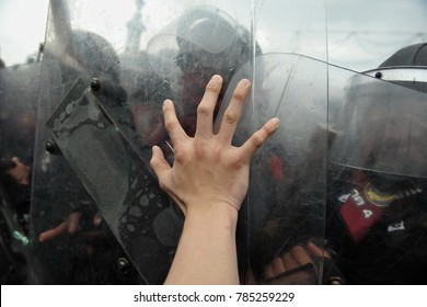 
Bangkok, Thailand - November 24, 2012: A protester pushes a police riot shield during clashes at an anti government rally.  - Shutterstock ID 785259229