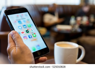 BANGKOK, THAILAND - NOVEMBER 26, 2016: Man Using Iphone7 Plus Jet Black Serie With Application Icons Of Social Media On Screen