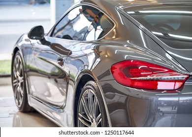 BANGKOK, THAILAND - NOVEMBER 26, 2018: The Shiny  Porsche Cayman S Sports Car With Gray Paint & Tail Light Detail After Ceramic Coat. Concept Of Car Detailing & Paint Protection. Side Shot From Behind