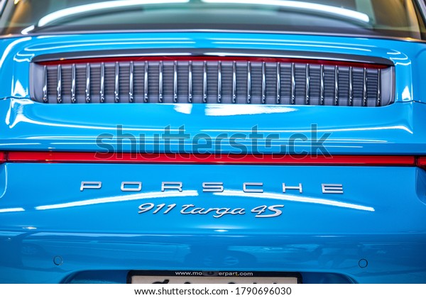 BANGKOK, THAILAND - NOVEMBER 26, 2018: Shiny \
Porsche 911 Targa 4S sports car with Miami blue paint & logo\
detail after ceramic coat. Concept of car detailing & paint\
protection. Front side\
view.