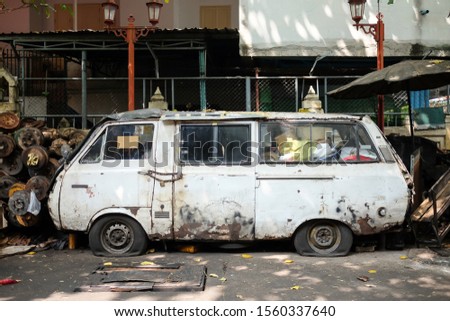 Bangkok / Thailand - November 3, 2019 : wreck white van with Flat car tire have a fetters on door