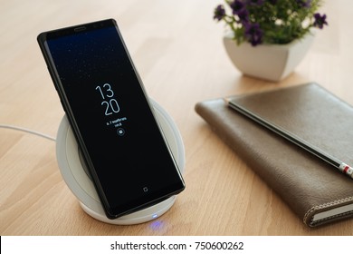 Bangkok, Thailand - November 7, 2017: Samsung Galaxy Note 8 is placed on a wireless fast charger.