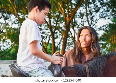 Bangkok, Thailand - Oct 11, 2018: 
Child With Special Needs Is Riding Horse And He Is Stubborn With The Teacher.
This Is A Treatment Called Hippo Therapy. 