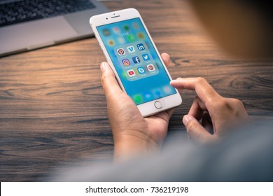 Bangkok, Thailand - OCT 17, 2017: Coronavirus prevention by work from home with app screen social media iphone 7 phone on desk wood - Shutterstock ID 736219198