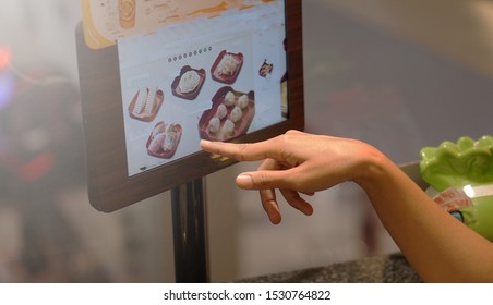 Bangkok, Thailand- October 14, 2019. Customer Orders Food By Using A Digital Touchscreen Menu At Their Table Inside An MK Restaurant. MK Restaurants Is The Most Popular In Thailand.   