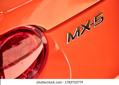 BANGKOK, THAILAND - OCTOBER 16, 2019: Rear view of Mazda MX5 with reflection on orange paint. Luxury sports car after paint polishing & ceramic coat. Car detailing & paint protection background