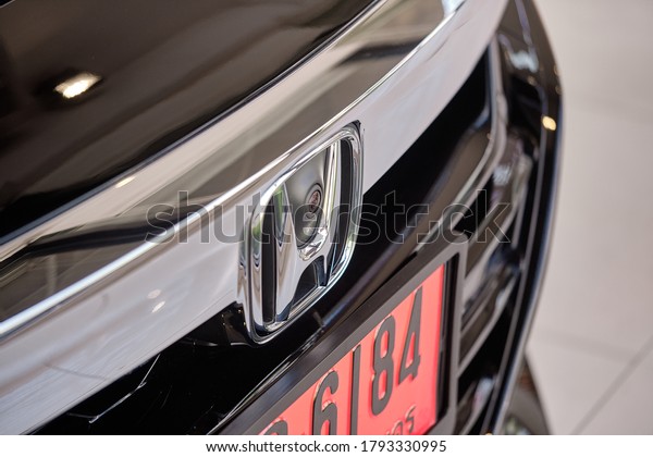 BANGKOK, THAILAND - OCTOBER 16, 2019: Front\
view of Honda Accord. Close up on Honda logo & frontview\
camera sensor. Hybrid model of full size family sedan. Japanese car\
company.  Car\
background