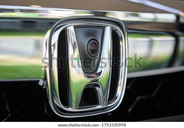 BANGKOK, THAILAND - OCTOBER 16, 2019: Close up\
on frontview camera sensor & Honda logo. Front view of Honda\
Accord.  Hybrid model of full size family sedan. Japanese car\
company.  Car\
background
