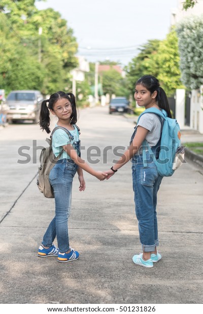 BANGKOK, THAILAND-\
OCTOBER 20, 2016: Happy Asian kid students walk to school safety\
during back to school\
month