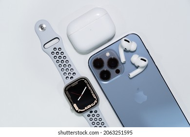 BANGKOK - THAILAND OCTOBER 22 2021 : Top view of the new iPhone 13 Pro Max Sierra Blue Color and the new apple watch series 7 starlight color with airpod pro with charging case on white background.
