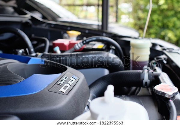BANGKOK, THAILAND - OCTOBER 26, 2020: Close up\
of Isuzu commercial vehicles & diesel engines with logo. \
Isuzu Motors is Japanese car brand & company focus on pick up\
truck. Garage & car fix\
concept.