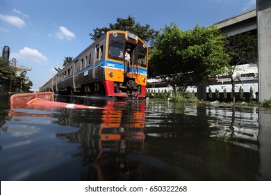 BANGKOK  THAILAND - OCTOBER 31 2011: The Diesel railcar comuter train was going to donmuang station  drown in the water at Don Muang Ithe massive flood crisis on October 31, 2011 in Bangkok.