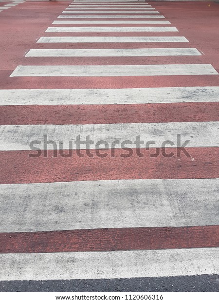Bangkok,\
Thailand on 24 June,2018. It\'s a crosswalk in white and red tone.\
It\'s new funcion for red one for prevent people fall when the floor\
has water. Transportation and first aid\
concept.