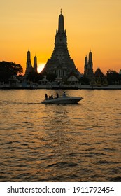 Bangkok, Thailand, Saturday 6 February 2021 : Tourists sitting on jet boat cruising at Chao Phraya River to see Wat Arun Temple or Temple of dawn at Sunset time