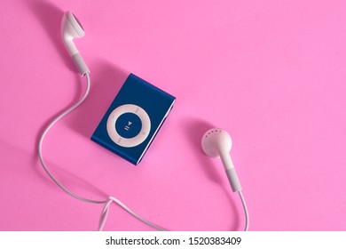 BANGKOK, THAILAND - SEP 22, 2019: Flat lay of iPod shuffle and headphone on pink background with copy space. Apple Inc. Product