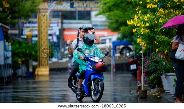 BANGKOK,\
THAILAND – SEPTEMBER 1: Motorbike taxi and customer on rainy days\
on September 1, 2020 in Bangkok,\
Thailand.