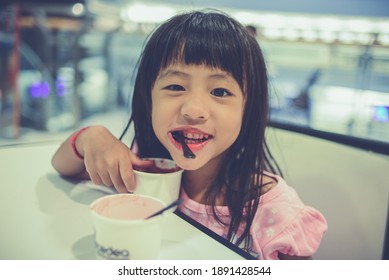 BANGKOK, THAILAND - SEPTEMBER 2017: Vintage Soft Focus Photo Of A Little Happy Adorable Asian Girl Eating Ice-cream. Cute Korean Thai Kid Enjoying Ice Cream. 