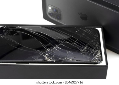 Bangkok, Thailand, September 21, 2021. Image of Apple iPhone 11 Pro max falling to the ground, cracked screen on white background.
