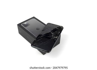 Bangkok, Thailand, September 21, 2021. Image of Apple iPhone 11 Pro max falling to the ground, broken screen on white background.