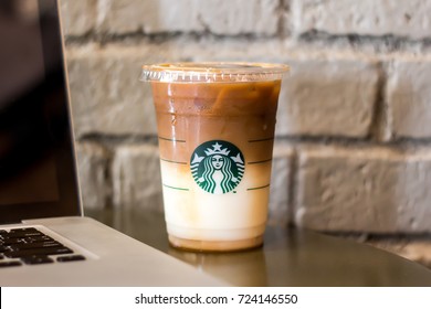 Bangkok, Thailand - September 27, 2017 : A Glass Of Drink, Starbucks Ice Coffee On Gray Brick Background.