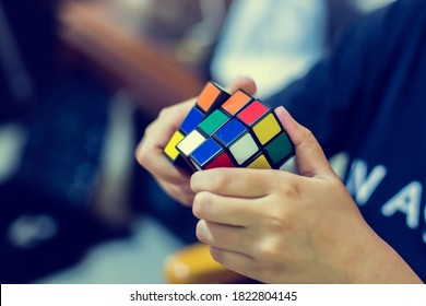 Bangkok, Thailand - September 7, 2020 : Woman solving Rubik's Cube. Hand holding colorful Rubik's cubes. Rubik's Cube was invented in 1974. - Shutterstock ID 1822804145