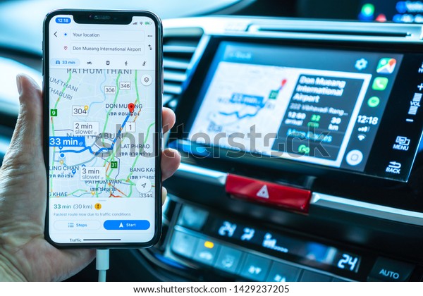 BANGKOK,\
THAILAND-16 May, 2019: Google map on Apple CarPlay app on iPhone X\
smart mobile application connected to Honda car for online gps road\
travel map, transportation vehicle\
safety