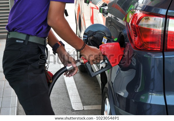 Bangkok, Thailand-Fabuary 12, 2018 : Oil station\
staff is refuel for\
car.