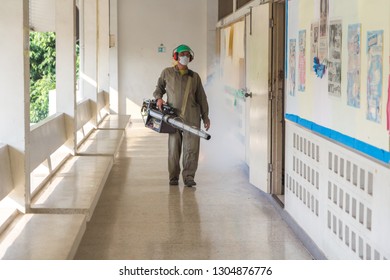 BANGKOK, THAILAND-FEBRUARY 05,2019: Men are using smoke machines to get rid of mosquitoes in schools. - Shutterstock ID 1304876776