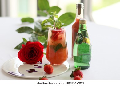 Bangkok, Thailand-January 15, 2021 Strawberry Juice And Perrier Brand Sparkling Water, Strawberry Juice Bottle And Red Rose On White Table. Close-up.