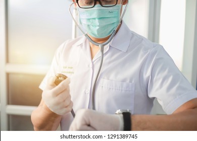 Bangkok, Thailand-January 19, 2019: Doctor Holding Stethoscope While Looking At Watch. Selective Focus. This Picture Can Be Used In Such Concepts As Med Student, Doctor, Hospital, Clinic And So On.  