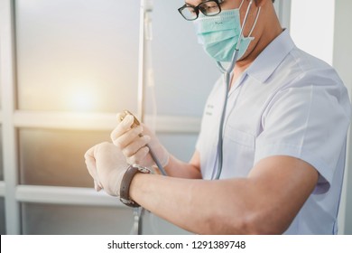 Bangkok, Thailand-January 19, 2019: Doctor Holding Stethoscope While Looking At Watch. Selective Focus. This Picture Can Be Used In Such Concepts As Med Student, Doctor, Hospital, Clinic And So On.  