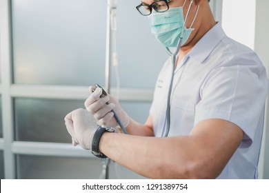 Bangkok, Thailand-January 19, 2019: Doctor Holding Stethoscope While Looking At Watch. Selective Focus. This Picture Can Be Used In Such Concepts As Med Student, Doctor, Hospital, Clinic And So On.  