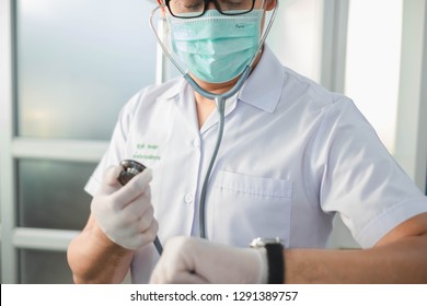 Bangkok, Thailand-January 19, 2019: Doctor Holding Stethoscope While Looking At Watch. Selective Focus. This Picture Can Be Used In Such Concepts As Med Student, Doctor, Hospital, Clinic And So On.  