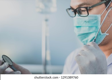 Bangkok, Thailand-January 19, 2019: Doctor Holding Stethoscope While Looking At Watch. Selective Focus. This Picture Can Be Used In Such Concepts As Med Student, Doctor, Hospital, Clinic And So On.  