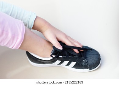 Bangkok ,Thailand,July 18 ,2018-kid Hand Touch Adidas Superstar Shell Toe Originals Sneaker Shoe