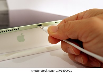 Bangkok ,THAILAND-Jun 14,2021: New Apple Pencil 2 For Ipad Air 4 In Man's Hand While Holding Wires Charge ,close Up Shot