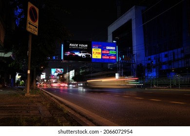 BANGKOK, THAILAND-OCTOBER 26,2021: LED Billboard Screen At Night Time, The Daily Charge Reported COVID-19 Infections Are Decreasing In Thailand, With 7,706 New Infections Reported On Average Each Day.