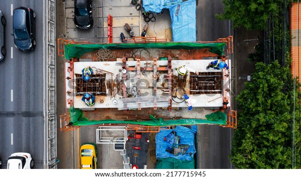 Bangkok urban Mass Transit Project (Pink\
Line Monorail). Aerial top view Construction of pink line monorail\
rail transit line in progress.Guide way beam, Light rail transit,\
construction machinery.  \
