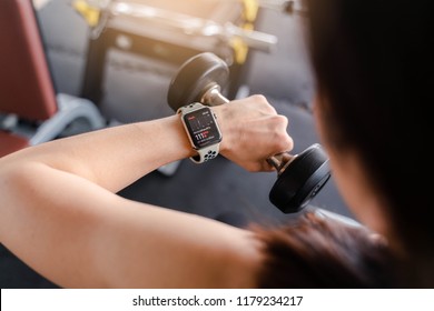 Bangkok,Thailand ,11 Sep 2018 : Close Up Of Apple Watch Heart Rate App View Woman Dumbbell Workout Fitness Gym