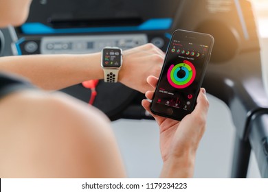 Bangkok,Thailand ,11 Sep 2018 : Screen Apple Watch And IPhone Activity App View Asia Woman Running  Electric Treadmill Work Out Fitness Gym