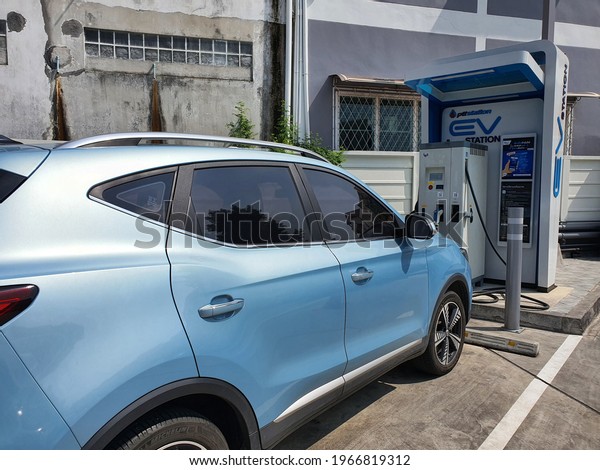 Bangkok,Thailand 1May 2021:Ecotricity electric\
vehicle charging point at the motorway service station with a blue\
car Plugged in and\
charging