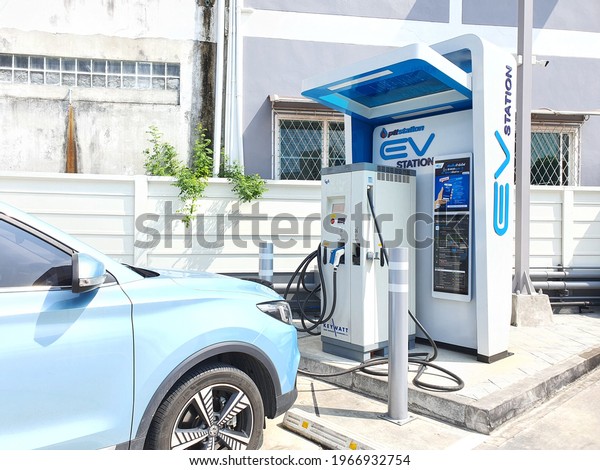 Bangkok,Thailand 1May 2021:Ecotricity electric\
vehicle charging point at the motorway service station with a blue\
car Plugged in and\
charging