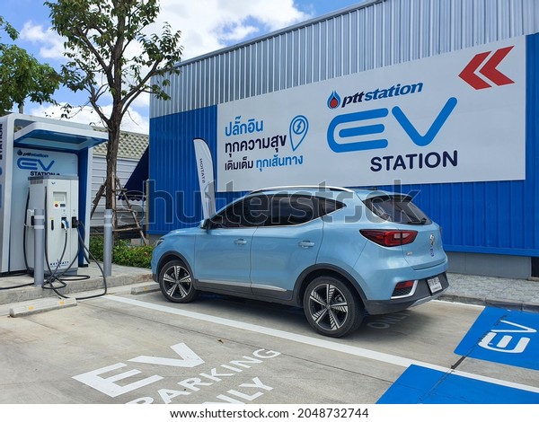 Bangkok,Thailand 27 SEP 2021:Photos of the parked blue\
MG - ZS EV electric car. Electric charger at the charging cradle of\
the Ptt gas station. \
