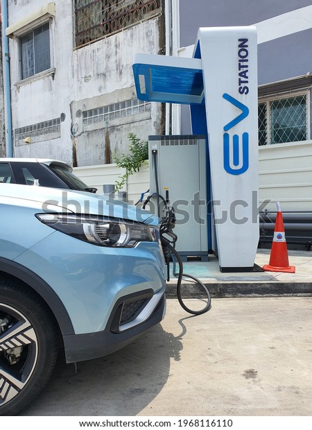 Bangkok,Thailand 3May 2021: Photos of the\
parked blue MG ZS EV electric car. Electric charger at the charging\
cradle of Ptt gas\
station.\
\
